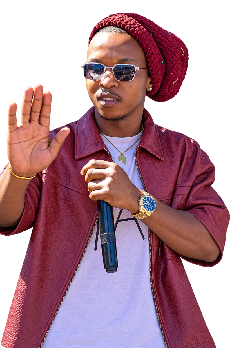 Ntate Stunna in a maroon leather jacket and crochet beanie, holding a mic, palm raised